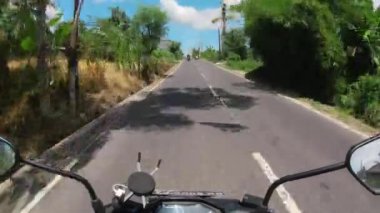 Asfalt yolda motosiklet sürmek Bali 'deki ilk insan