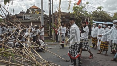 Desa Munggu, Mengwi, Kabupaten Badung, Bali, Endonezya - 26 Eylül 2020: Tören Mekotek. Mekotek, Hindular tarafından yüzyıllardır Bali 'de ilan edilen bir miras. Erkeklerin tuttuğu uzun sopalı bir ayin..