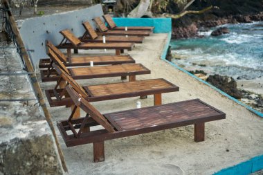 Boş şezlonglar lüks otelin yakınında deniz kenarında makara yapıyor. Yaz tatili için dinlenme odası modeli