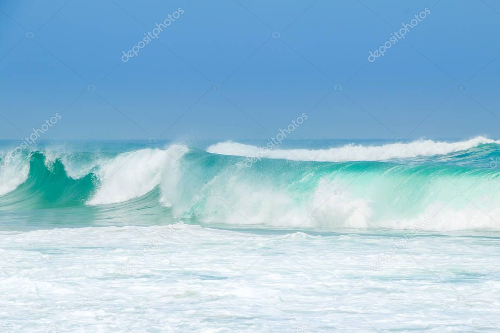 Endless ocean. A large green wave of surf and plenty of foam in the foreground