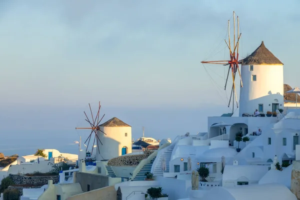 Greece. Thira island. Santorini. White houses and windmills on a mountainside in the Oia town