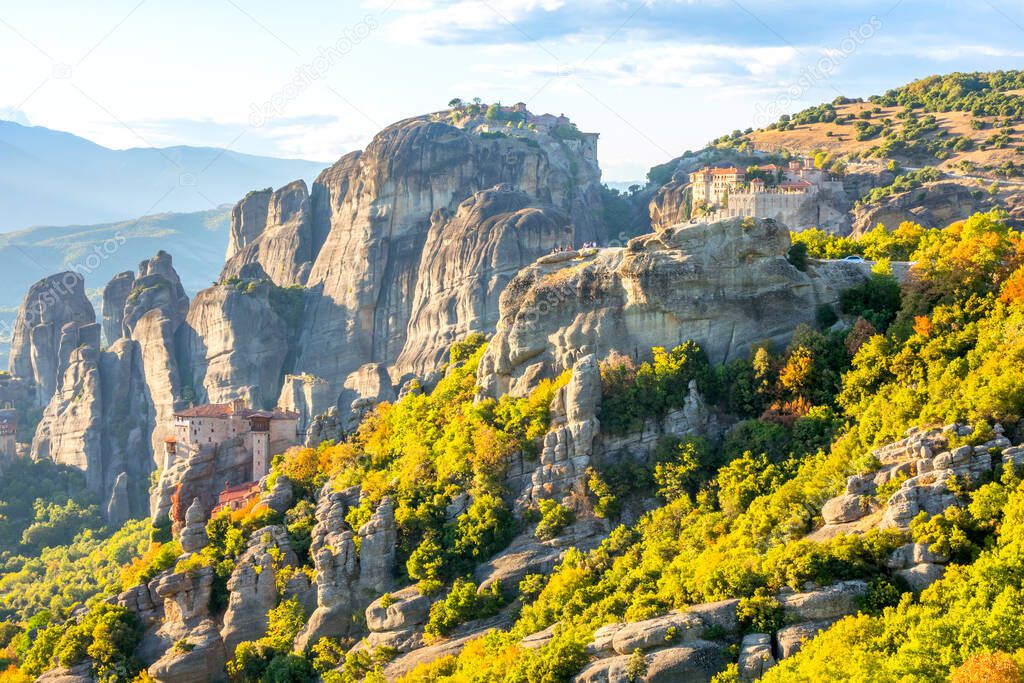 Greece. Sunny summer day in the Kalambaka valley. Stone monasteries Meteora at the top of the cliffs