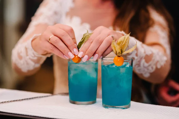 fresh blue juice in glasses on bar counter at nightclub