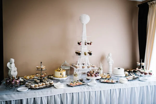 Sweet table with assorti of sweets on wedding holiday