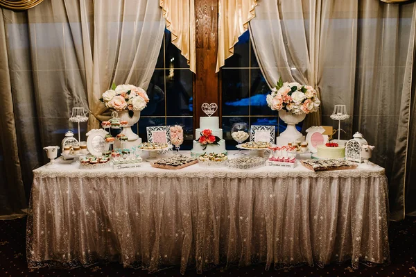 Colorful table with sweets and goodies for wedding party reception
