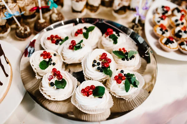 Sweet table with sweets, cakes, candy on wedding buffet