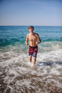 okyanus suyunda çizgili kısa poz genç adam