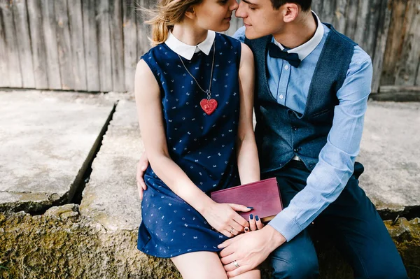 Young Couple Sitting Hugging Holds Closed Book His Hands Wooden — Stock Photo, Image