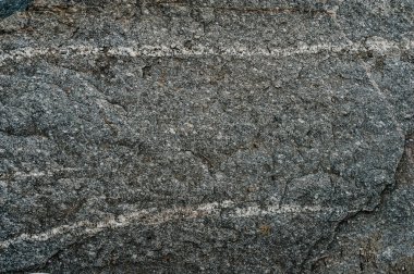 Taş dokusu arka planı. Granit ve bazalt yüzeyi. Büyük bir kaya, taş bir duvar. Kapat. metin için yer.