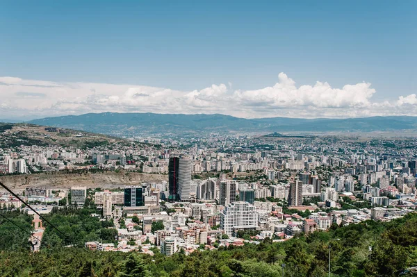 Top view from the highest point to the new and old houses, skyscrapers, city, town, and most famous park in Tbilisi is the capital of Georgia.