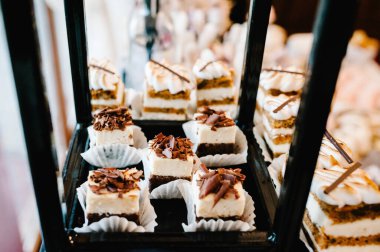 Güzel masa. Bir tabak kek. Şekerli masa, açık büfe. Parti şekerlemeleri için tatlı masası. Parti resepsiyonu, restoranda çok lezzetli süslenmiş. Şeker çubuğu.