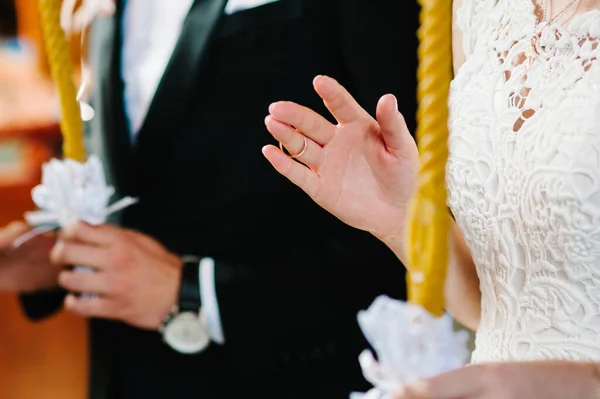 Hand of the bride with gold ring on the finger. Wedding ceremony. Close up. Engagement wedding rings.