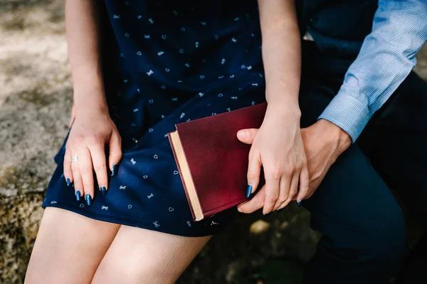 Hands Young Couple Holds Closed Book Knees Woman Man Holds — Stock Photo, Image