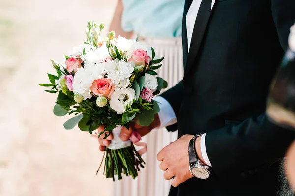 スタイリッシュな新郎はブライダル花束を保持しています 結婚式の花束で男の手 — ストック写真