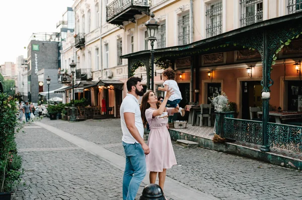 Young Happy Family Father Daughter Mother Throws Baby Walk Streets — Stock Photo, Image