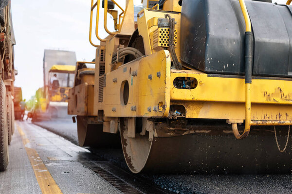 Compactor roller during road construction. At asphalting work. Thailand. with sun light