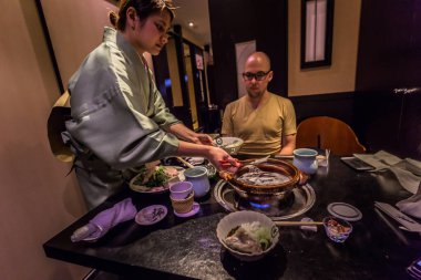 Tokyo - 20 Mayıs 2019: Ginza distri'de Pufferfish yiyen turistler