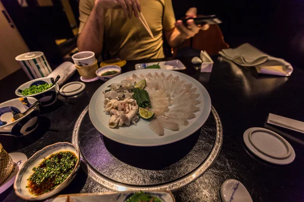 Tokyo - May 20, 2019: Tourists eating Pufferfish in Ginza distri — Stock Photo, Image