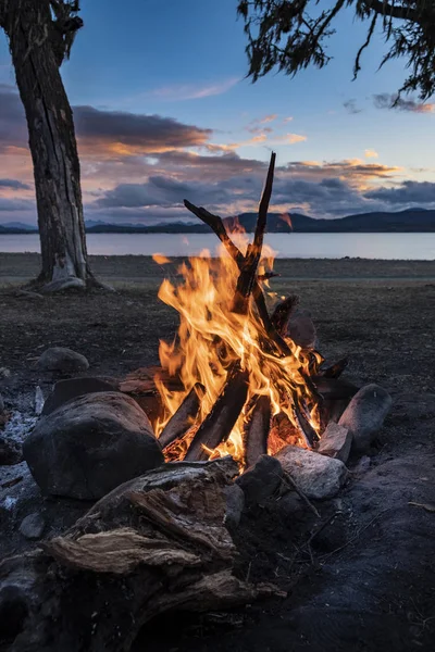 Campfire by a lake at sunset. Tierra del Fuego, Argentina 1