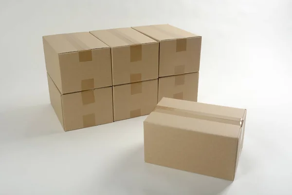 Unmarked Stacked Cardboard Boxes White Surface — Stock Photo, Image
