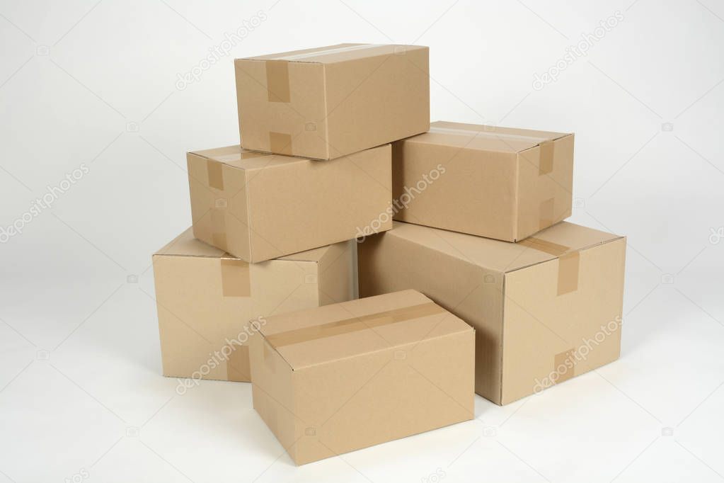 unmarked heap of cardboard boxes on white surface