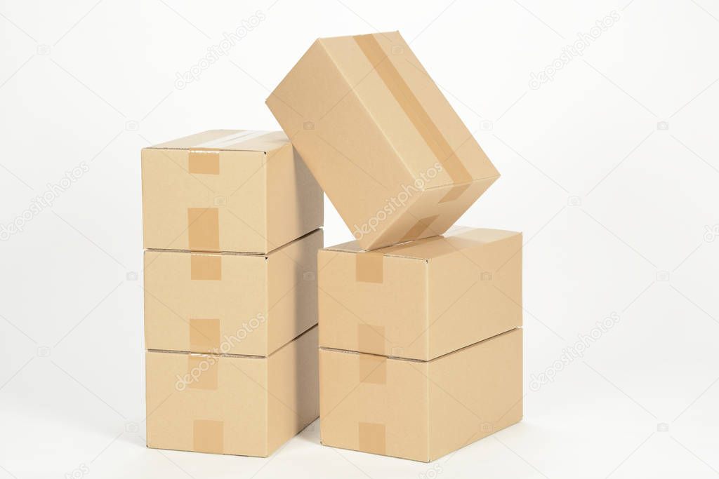 unmarked heap of cardboard boxes on white surface