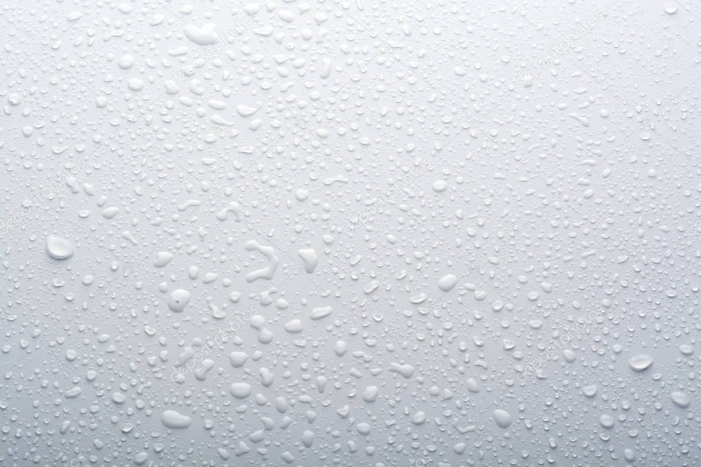 full frame shot of water drops on white surface