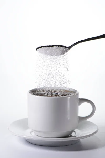 Sugar falling from a spoon — Stock Photo, Image