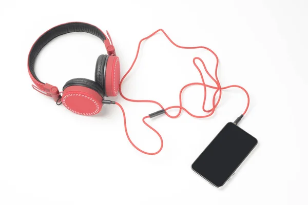 Auriculares y teléfono rojos — Foto de Stock