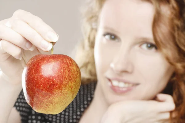 Young girl holding an apple. Healthy food