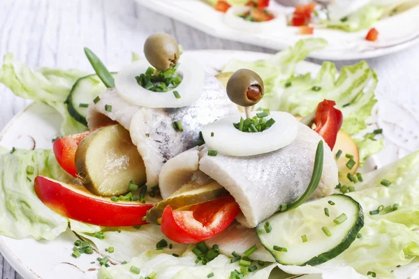 Pickled herring rolls. Party dish