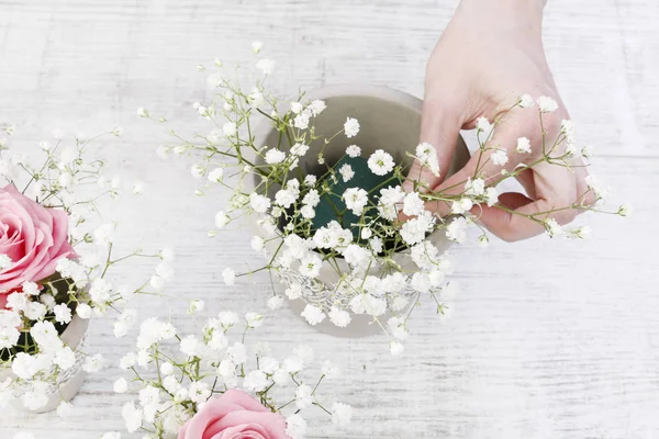 Het maken van decoraties met roze rozen en witte Gypsophila panicula — Stockfoto