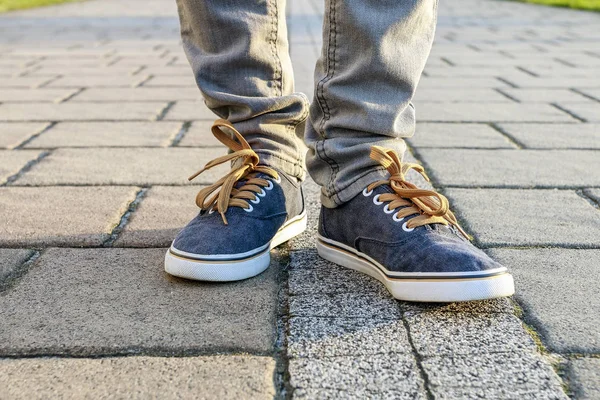 Young person wearing sneakers, walking on the pavement. — Stock Photo, Image