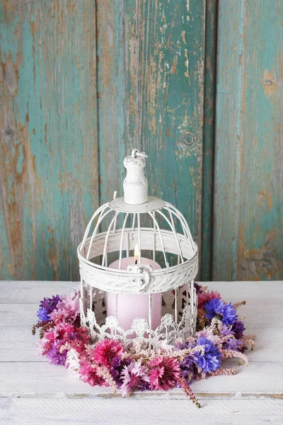 Cornflower wreath and vintage birdcage. — Stock Photo, Image