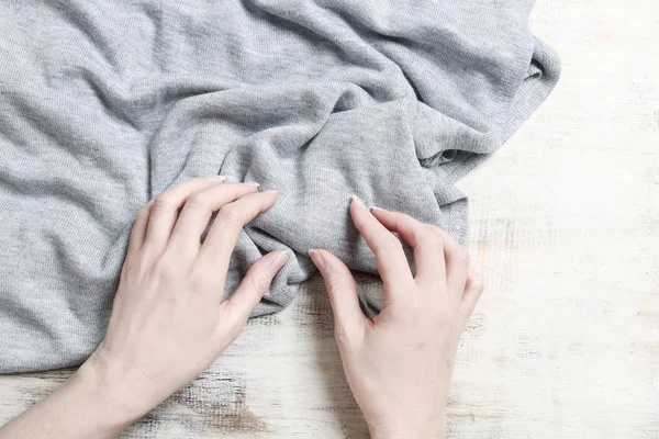 Woman checks the quality of fabric.