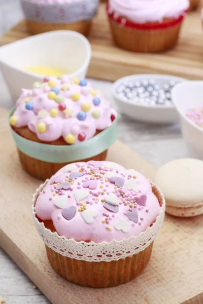 Rosa Muffins mit bunten Streuseln verziert. — Stockfoto