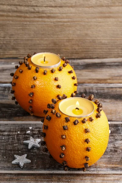 Orange pomander ball with candle. — Stock Photo, Image