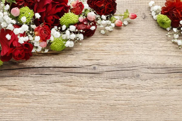Floral arrangement with orchids, roses and carnations on wooden — Stock Photo, Image