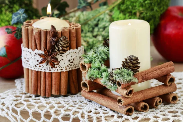 Candle decorated with cinnamon sticks — Stock Photo, Image