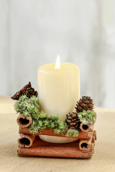 Candle decorated with cinnamon sticks — Stock Photo, Image