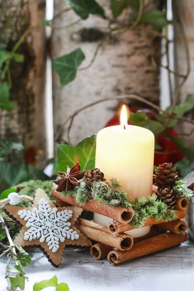 Candle decorated with cinnamon sticks — Stock Photo, Image