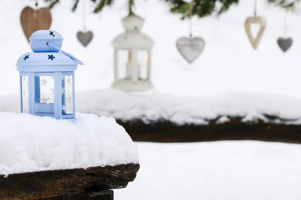 Lanterna blu sulla neve e cuori appesi con ghirlanda di abete nella — Foto Stock