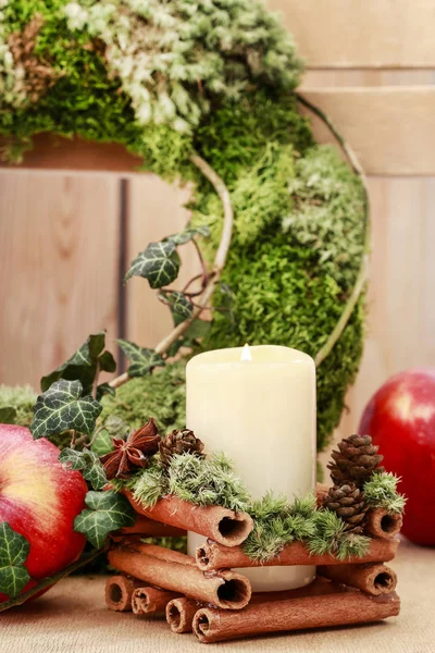 Candle decorated with cinnamon sticks — Stock Photo, Image