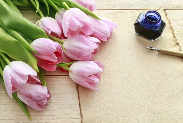 Beautiful pink and white tulips on wooden background — Stock Photo, Image