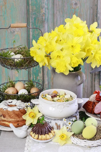 The sour rye soup, easter cakes and saussages on the table.