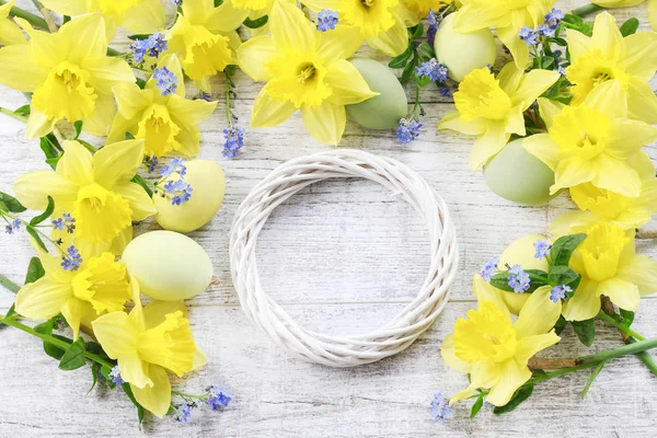 Hasır çelenk, sarı nergis ve paskalya yumurtaları, şenlikli dekor — Stok fotoğraf