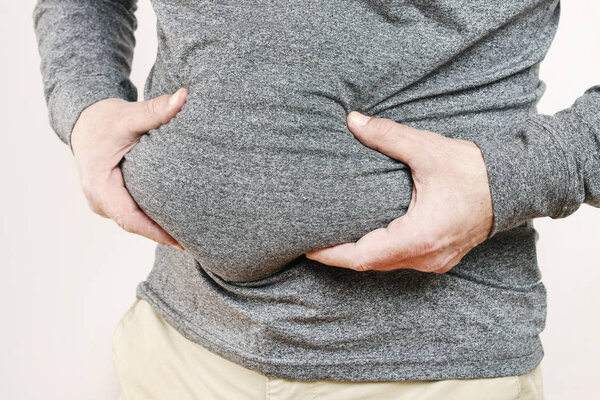Fat man holding his belly. 