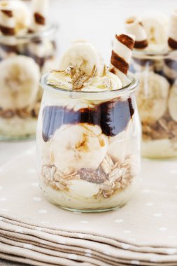 Müsli, çikolata ve muz meyvesi ile katman tatlısı.