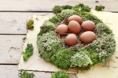 Yosun çelenk, saman ve yumurta ile Paskalya masası dekorasyonu. 