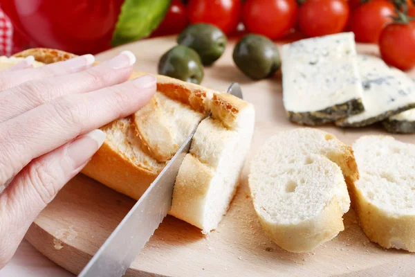 Cutting french baguette. — Stock Photo, Image